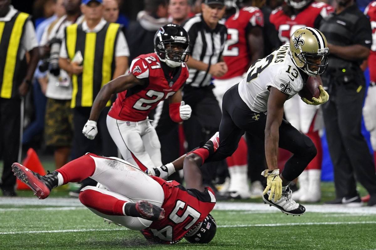 Sep 23, 2018; New Orleans Saints receiver Michael Thomas (13) runs through Atlanta Falcons linebacker Foye Oluokun (54). Mandatory Credit: Dale Zanine-USA TODAY Sports